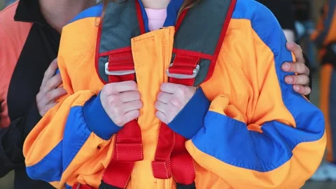 Practicing instructor checks the equipment before the tandem jump Stock Footage 247271104