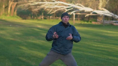 Practicing Kata Karate Man in the Hat Early in the Morning in the Woods Stock Footage 74693189