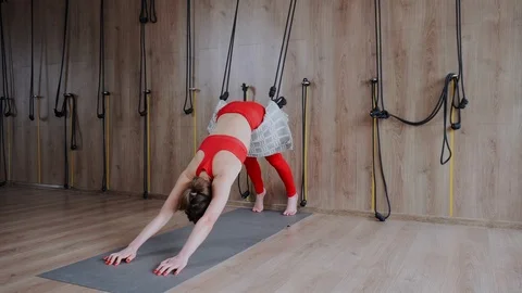 Practicing modern yoga with ropes in class. Stretching and fitness for women. Video stock 126569016