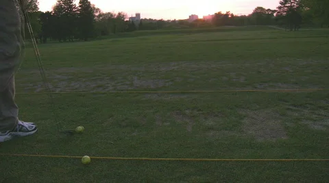 Practicing with the nine iron at driving range Stock Footage 693477