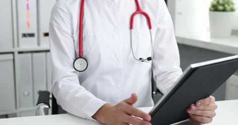 Practicing physician using tablet computer gives aremote medical consultation Stock Footage 166553622