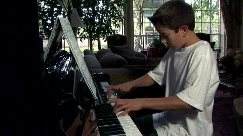 Practicing the piano full view Stock Footage