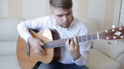Practicing in playing guitar. Handsome young men playing guitar Stock Footage 48677634