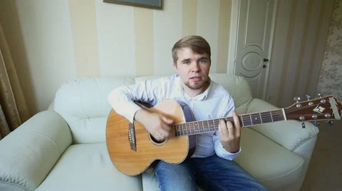 Practicing in playing guitar. Handsome young men playing guitar Stock Footage 50621889