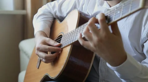 Practicing in playing guitar. Handsome young men playing guitar Stock Footage 50624780