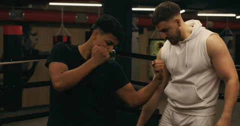 Practicing the punching technique of a boxer under the supervision of a coach. Stock Footage 275278928
