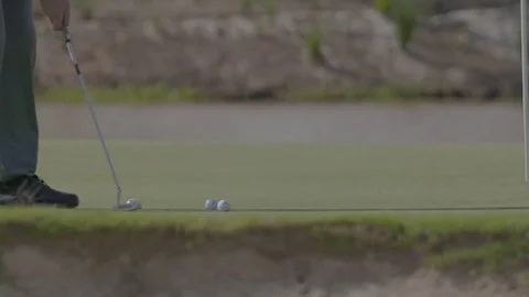 Practicing putting on golfing green Stock Footage 74061416