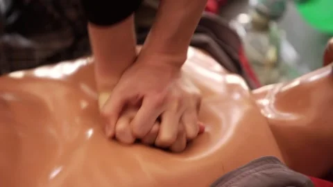 Practicing the resuscitation procedure on a mannequin during practical training Stock Footage 276897175
