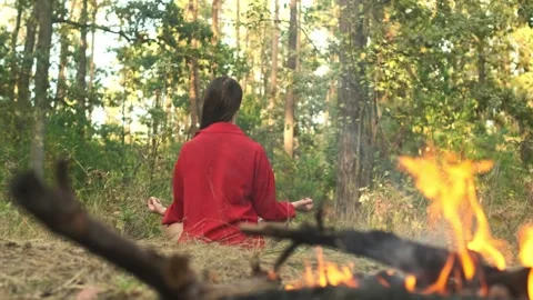 Practicing self-discovery through meditation. Woman meditating in a forest near Stock Footage 295862443