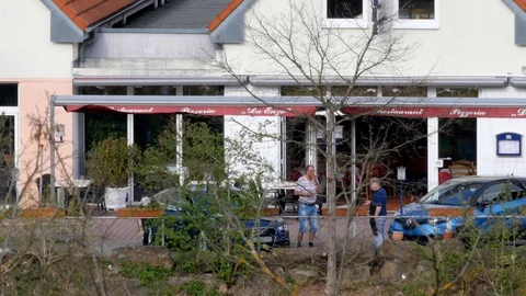 Practicing social distancing in front of restaurant, covid-19 pandemic, germany Stock Footage 128782113