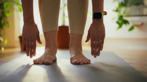 Practicing yoga indoors while focusing on balance and flexibility in the mor Stock Footage 300386642
