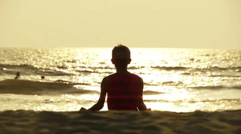Practicing yoga at sunset on Goa beach Stock Footage 36962477