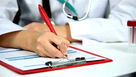 Practitioner filling medical documents, and writing prescription, Close up Stock-Footage 336588192