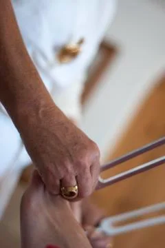 Practitioner giving healing tuning fork treatment. Stock Photos