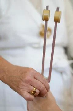 Practitioner giving healing tuning fork treatment. Stock Photos