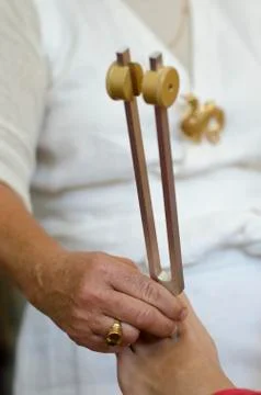 Practitioner giving healing tuning fork treatment. Stock Photos