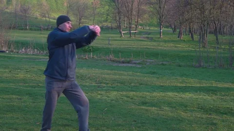 Practitioners of Karate Man Doing Kicks With a Turn at Dawn in the Spring Woods Stock Footage 74693309