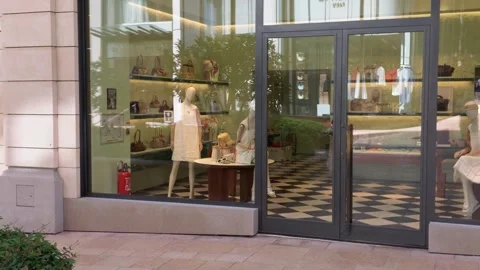 Prada luxury boutique window display pan right in Monte Carlo Stock Footage 337788399