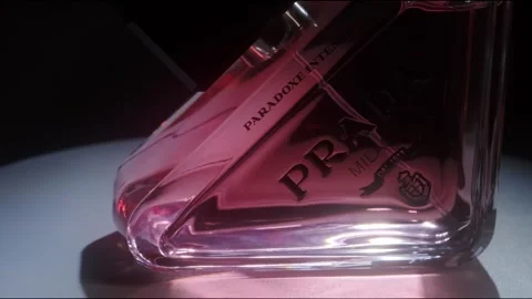 Prada Paradoxe Intense Perfume Rotating on White Surface Backlight Close Up Stock-Footage 334552405