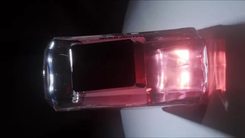 Prada Paradoxe Intense Perfume Rotating on White Surface Backlight Close Up Stock-Footage 334553494