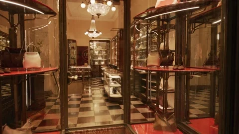 Prada SS26 boutique interior with elegant glass displays, designer handbags, and Stock Footage 330033603