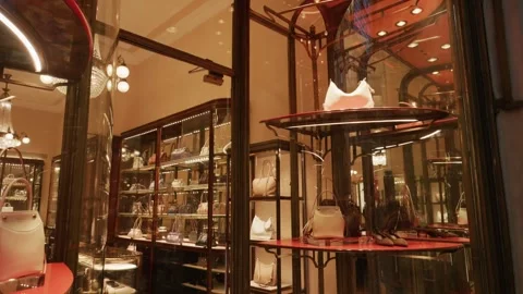 Prada SS26 boutique window with elegant handbags, chic lighting, and modern Stock Footage 330033604