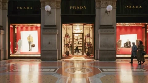 Prada SS26 boutique window with vibrant red displays, luxury fashion Stock Footage 330033682