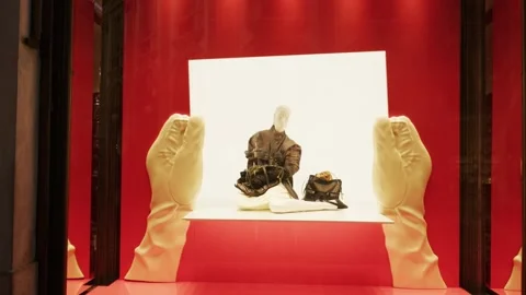 Prada SS26 window display with bold red backdrop, luxury handbags, and modern Stock Footage 330033608