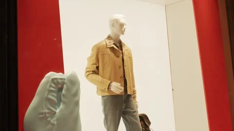 Prada SS26 window display features a stylish beige jacket on a mannequin, set Stock Footage 330033686