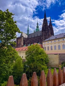 Prague Castle and the Gothic St. Vitus Cathedral under a cloudy blue sky Фото