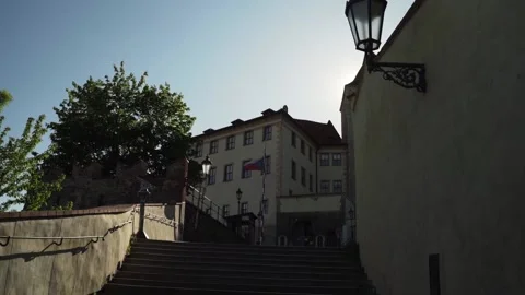 Prague castle with sun behind tower and czech flag Stock Footage 144454329