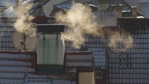 Prague City Rooftops and Buildings Under The Snow In Winter Smoke From Chimneys Stock Footage