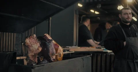 Prague, CZ - 01 12 2026:  Spit-roasted pork leg spinning slowly. Stock Footage 325333903