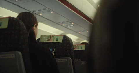 Prague, CZ - 01 12 2026:  Female passenger sitting on airline. Stock Footage 329450193