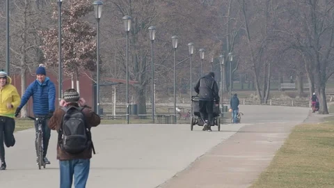 Prague, Czech Republic. 01-15-2021. A father running carrying his child in th Stock Footage 151521402