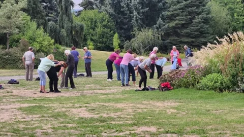 PRAGUE, CZECH REPUBLIC – AUGUST 26, 2026: People exercise together outdoors 4K 스톡 동영상 343656613