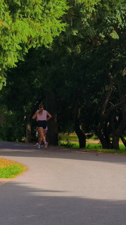 PRAGUE, CZECH REPUBLIC – AUGUST 28, 2026: Cyclists and Woman Running 4K 스톡 동영상 343925458