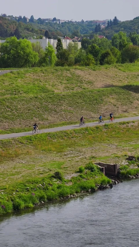 PRAGUE, CZECH REPUBLIC – AUGUST 28, 2026: Family of four cycling together 스톡 동영상 343925980