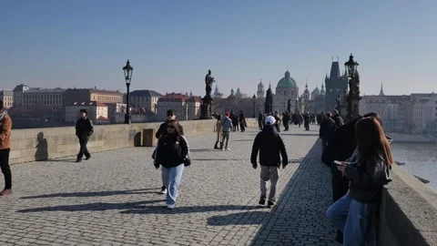 Prague, Czech Republic – March 5, 2026: Charles Bridge Tourists and Artists Stock Footage 330188853