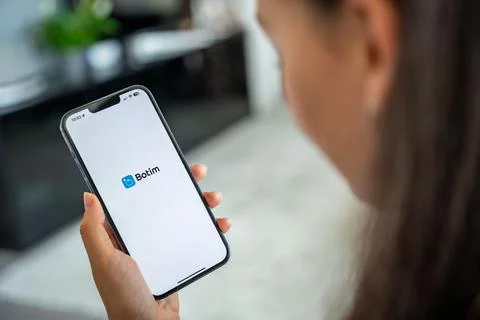 Prague, Czech republic - May 2, 2024: Woman holding iPhone with logo of Stock Photos