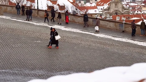 Prague - Elevated view of tourists walking and enjoying city view with snow. 4K Stock Footage 103409360
