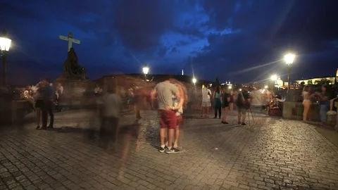 PRAGUE - JUNE 6: Time lapse shot of People walk at night on the Charles Bridge Stock Footage 76804305