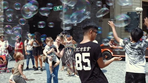Prague - People playing with soap bubbles in old town. 4K resolution. Stock Footage 94254975