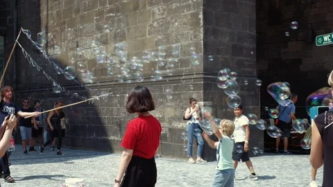 Prague - Performer creating soap bubbles in old town. 4K resolution. Stock Footage 94255022