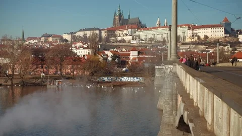Prague  - View of Prague Castle with bridge, people and steam in foreground. 4K Stock Footage 105763437