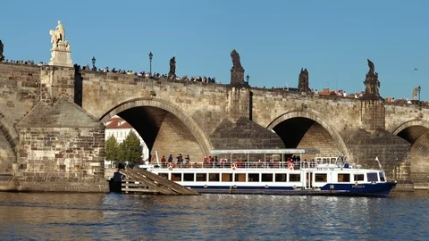 Prague - View of river with Charles Bridge and tourist boat. 4K resolution Stock Footage 95923095