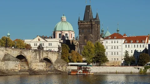 Prague - View of river with Charles Bridge, Old Town Bridge Tower and boat. 4K Stock Footage 95926734
