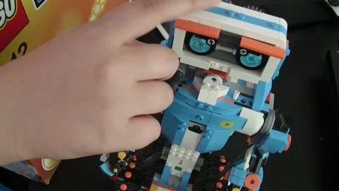 Prague,CZ-2016.07.06: constructs a Lego robot, Aimubot Basic Coding. Editorial Stock Footage 270954413