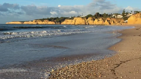 Praia do Vale do Olival golden sand beach with rock arch and cliffs, Algarve Video stock 333821202
