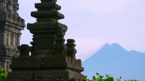 Prambanan Hindu temple complex against active volcano Mount Merapi. Indonesia Stock Footage 74399082
